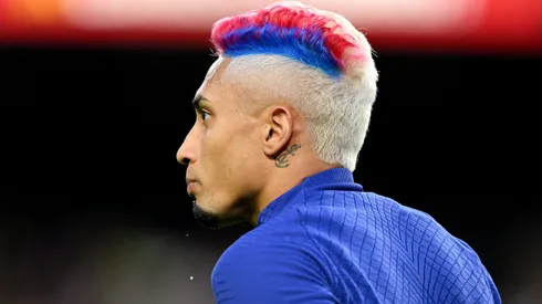 BARCELONA, SPAIN – MAY 20: Raphinha of FC Barcelona looks on, with a Blue and Red stripe in their hair, warms up prior to the LaLiga Santander match between FC Barcelona and Real Sociedad at Spotify Camp Nou on May 20, 2023 in Barcelona, Spain. (Photo by David Ramos/Getty Images)