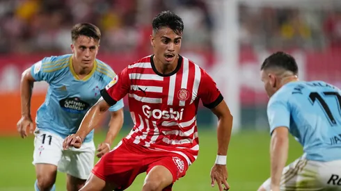GIRONA, SPAIN - AUGUST 26: Reinier Jesus of Girona FC is put under pressure by Franco Cervi and Javi Galan of RC Celta during the LaLiga Santander match between Girona FC and RC Celta at Montilivi Stadium on August 26, 2022 in Girona, Spain. (Photo by Alex Caparros/Getty Images)