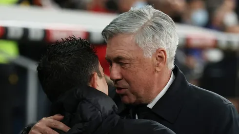 Manager Carlo Ancelotti (R) of Real Madrid CF hugs manager Xavi Hernandez (L) of FC Barcelona (Photo by Gonzalo Arroyo Moreno/Getty Images)