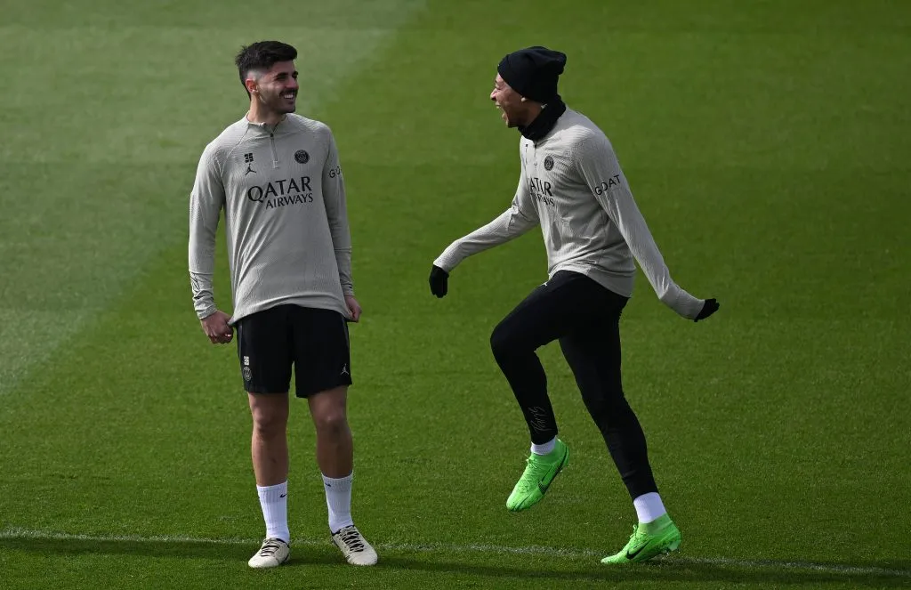 Kylian Mbappé laughs with Lucas Beraldo of PSG(Photo by Stuart Franklin/Getty Images)