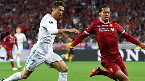 Cristiano Ronaldo of Real Madrid CF competes for Virgil van Dijk . (Photo by David Ramos/Getty Images)