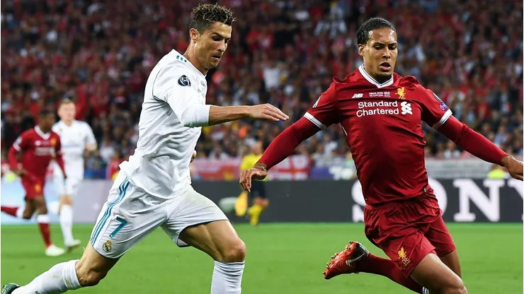 Cristiano Ronaldo of Real Madrid CF competes for Virgil van Dijk . (Photo by David Ramos/Getty Images)