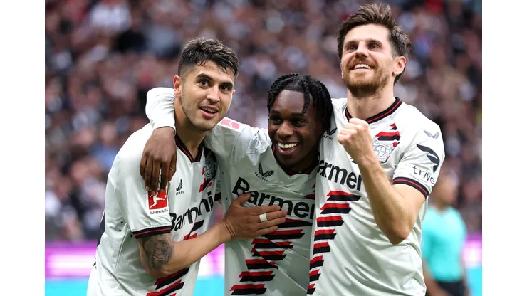 FRANKFURT AM MAIN, GERMANY - MAY 05: Jeremie Frimpong of Bayer Leverkusen celebrates scoring his team's fourth goal with teammates Exequiel Palacios and Jonas Hofmann during the Bundesliga match between Eintracht Frankfurt and Bayer 04 Leverkusen at Deutsche Bank Park on May 05, 2024 in Frankfurt am Main, Germany. (Photo by Alex Grimm/Getty Images)