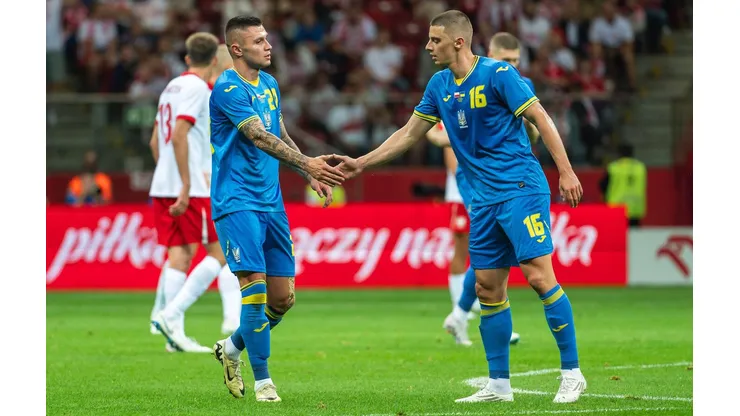 Zubkow e Mykolenko se cumprimentam após gol da Ucrânia no amistoso contra a Polônia. (Dziurek - Sport / Alamy Stock Photo)