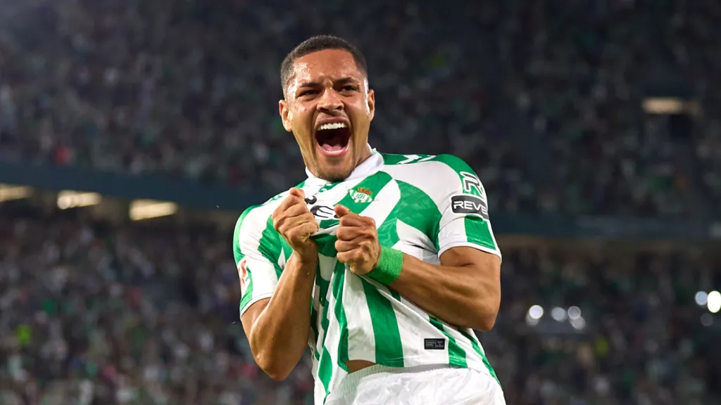 Vitor Roque celebra gol em campo com camisa do Real Betis verde e branca (Foto: Fran Santiago/Getty Images)