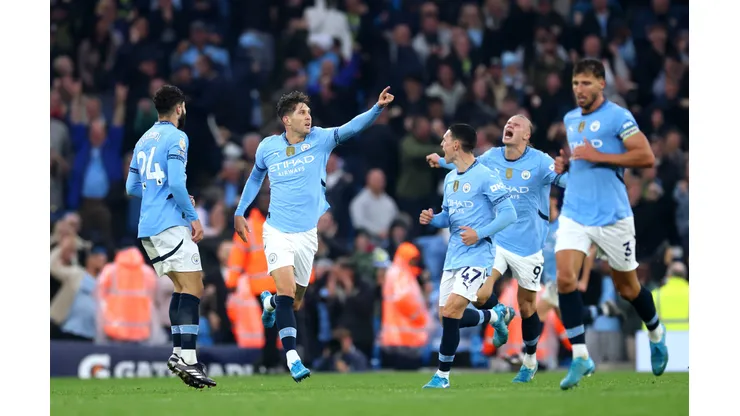 MANCHESTER, ENGLAND - SEPTEMBER 22: John Stones of Manchester City celebrates scoring his team's second goal with teammates during the Premier League match between Manchester City FC and Arsenal FC at Etihad Stadium on September 22, 2024 in Manchester, England. (Photo by Carl Recine/Getty Images)