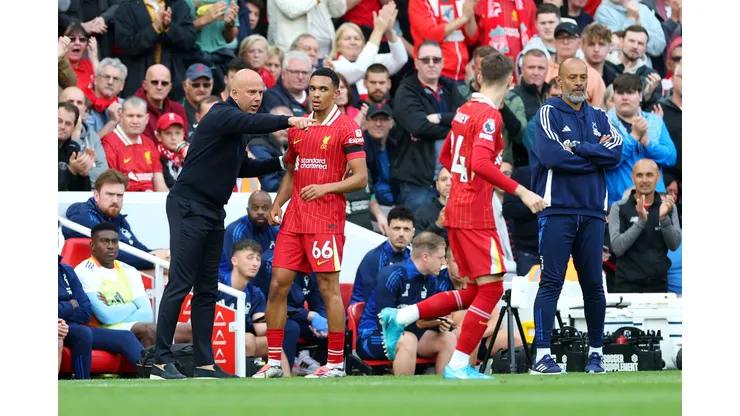 LIVERPOOL, ENGLAND - SEPTEMBER 14: Arne Slot, Manager of Liverpool, talks to Trent Alexander-Arnold of Liverpool during the Premier League match between Liverpool FC and Nottingham Forest FC at Anfield on September 14, 2024 in Liverpool, England. (Photo by Carl Recine/Getty Images)