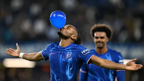 LONDON, ENGLAND - SEPTEMBER 24: Christopher Nkunku of Chelsea celebrates scoring his team's fifth goal, and completing his hattrick by blowing up a ballon during the Carabao Cup Third Round match between Chelsea and Barrow at Stamford Bridge on September 24, 2024 in London, England. (Photo by Mike Hewitt/Getty Images)