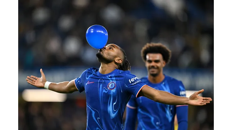 LONDON, ENGLAND - SEPTEMBER 24: Christopher Nkunku of Chelsea celebrates scoring his team's fifth goal, and completing his hattrick by blowing up a ballon during the Carabao Cup Third Round match between Chelsea and Barrow at Stamford Bridge on September 24, 2024 in London, England. (Photo by Mike Hewitt/Getty Images)