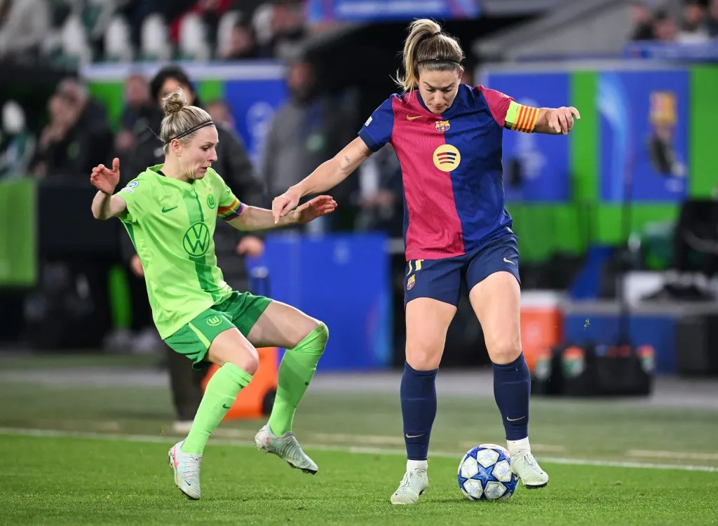 WOLFSBURG, GERMANY – MARCH 19: Alexia Putellas of FC Barcelona is challenged by Svenja Huth of VfL Wolfsburg during the UEFA Women’s Champions League quarterfinals first leg match between VfL Wolfsburg and FC Barcelona at VfL Wolfsburg Arena on March 19, 2025 in Wolfsburg, Germany. (Photo by Stuart Franklin/Getty Images)