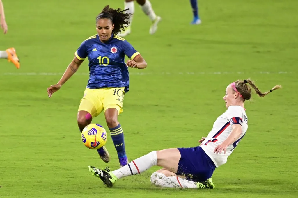 ORLANDO, FLORIDA – JANUARY 18: Becky Sauerbrunn #4 of the United States tackles the ball from Gisela Robledo #10 of Colombia during the first half at Exploria Stadium on January 18, 2021 in Orlando, Florida. (Photo by Douglas P. DeFelice/Getty Images)