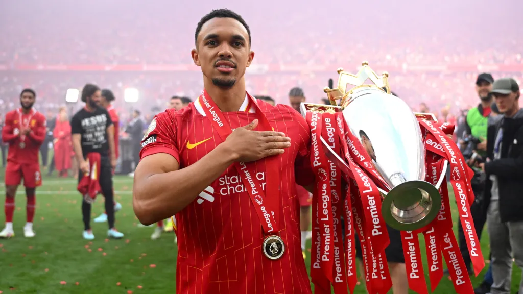 Trent Alexander-Arnold bate no peito com a mão enquanto segura o troféu da Premier League (Photo by Michael Regan/Getty Images/Getty Images For The Premier League)