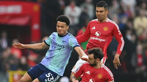 MANCHESTER, ENGLAND - MARCH 09: Ethan Nwaneri of Arsenal is challenged by Bruno Fernandes and Casemiro of Manchester United during the Premier League match between Manchester United FC and Arsenal FC at Old Trafford on March 09, 2025 in Manchester, England. (Photo by Michael Regan/Getty Images)