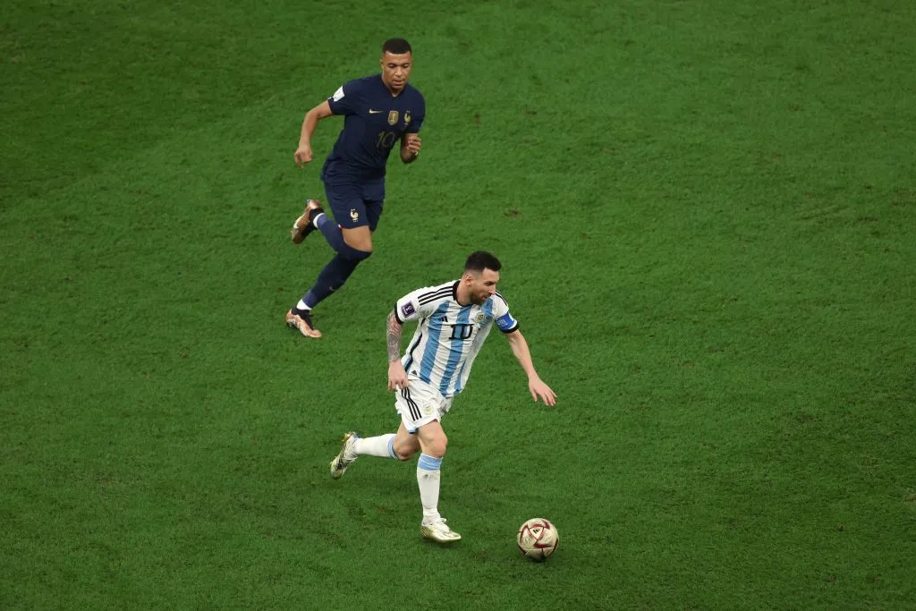 LUSAIL CITY, QATAR – DECEMBER 18: Lionel Messi of Argentina is chased by from Kylian Mbappe of France  during the FIFA World Cup Qatar 2022 Final match between Argentina and France at Lusail Stadium on December 18, 2022 in Lusail City, Qatar. (Photo by Alex Pantling/Getty Images)