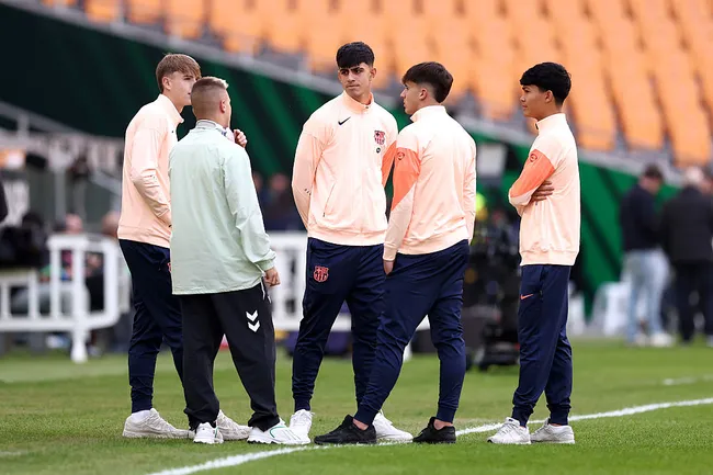 Jogadores do FC Barcelona interagem com Pablo Garcia, do Real Betis, durante a inspeção do gramado antes da partida da LaLiga EA Sports entre Real Betis Balompié e FC Barcelona, ​​no Estádio La Cartuja, em 6 de dezembro de 2025, em Sevilha, Espanha. (Foto de Fran Santiago/Getty Images)