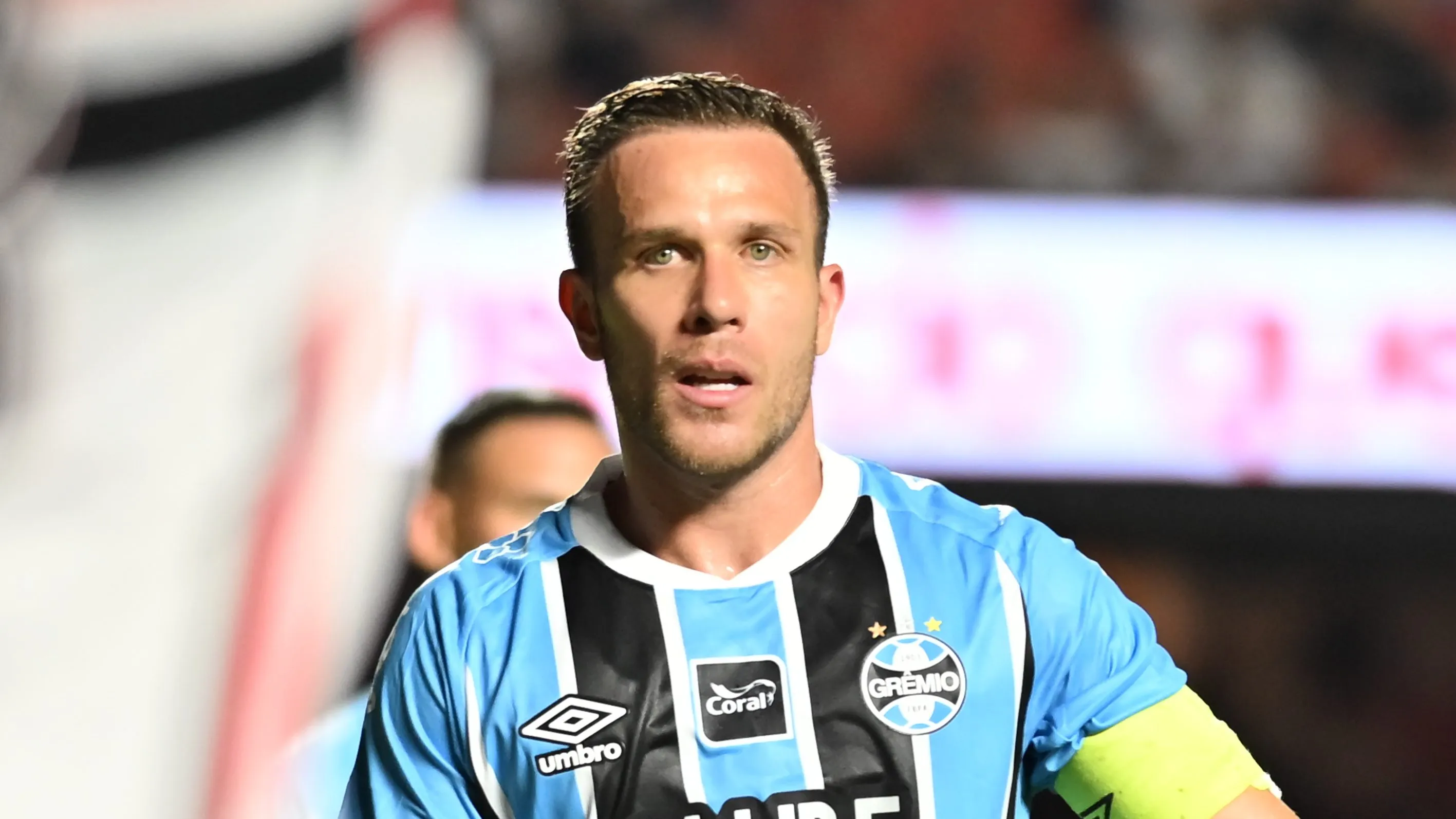 Arthur veste a camisa tricolor do Grêmio e usa a faixa de capitão