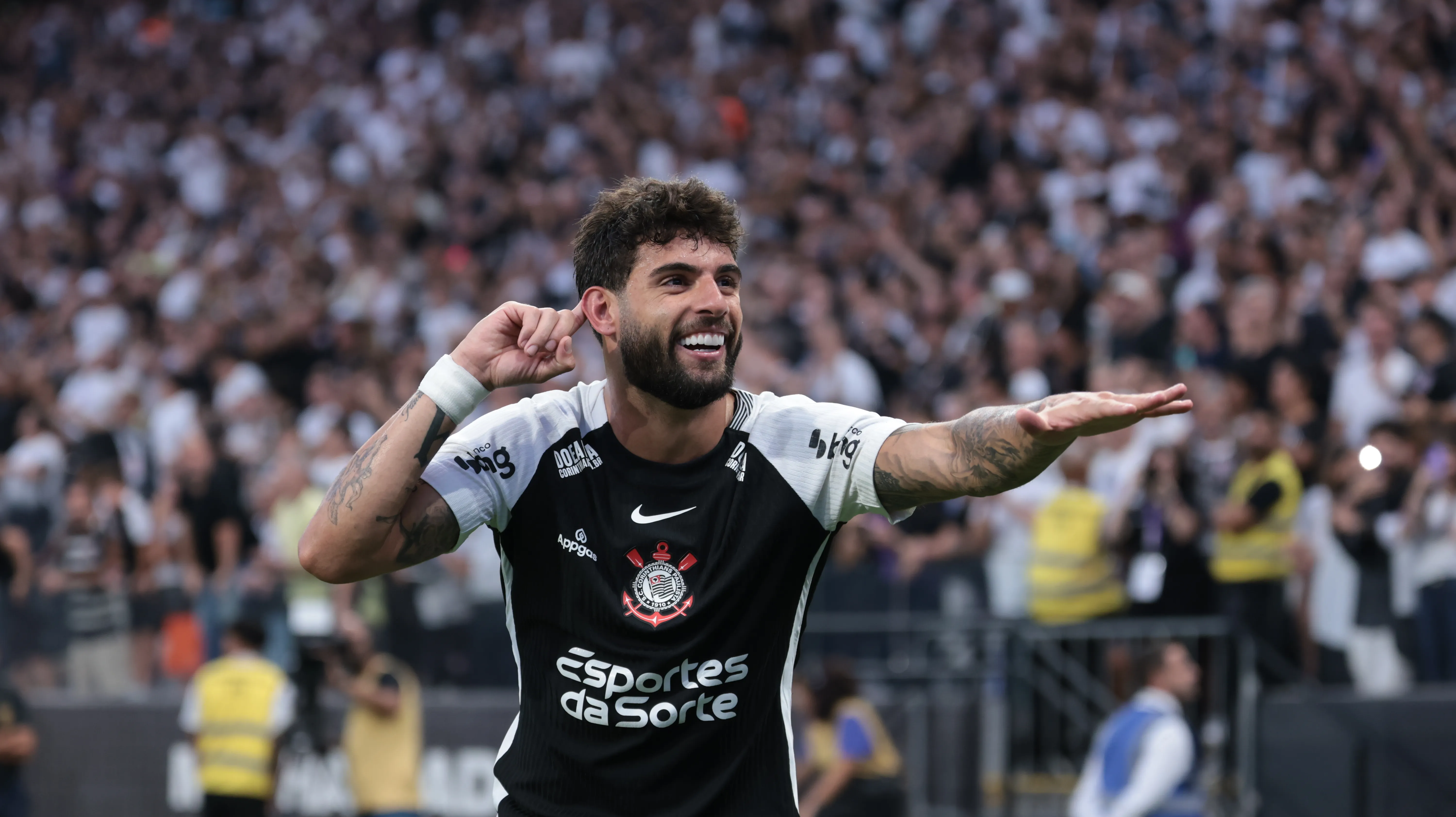 Yuri Alberto sorrindo com dedo indicador no ouvido