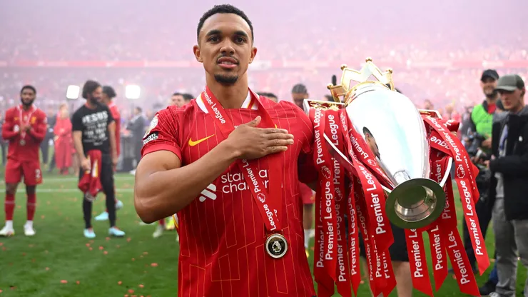 Trent Alexander-Arnold of Liverpool, celebrates with Premier League trophy after his final appearance for Liverpool as Liverpool are crowned the Champions of the Premier League for the 2024/25 Season, following the Premier League match between Liverpool FC and Crystal Palace FC at Anfield on May 25, 2025 in Liverpool, England.