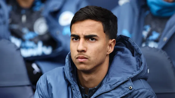 Vitor Reis of Manchester City looks on from the substitutes bench during the Premier League match between Manchester City FC and Brighton & Hove Albion FC at Etihad Stadium on March 15, 2025 in Manchester, England.