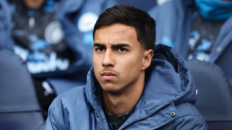 Vitor Reis of Manchester City looks on from the substitutes bench during the Premier League match between Manchester City FC and Brighton & Hove Albion FC at Etihad Stadium on March 15, 2025 in Manchester, England.