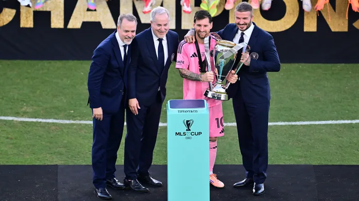 FORT LAUDERDALE, FLORIDA - DECEMBER 06: Lionel Messi #10 of Inter Miami CF poses with Miami owners Jose Mas, Jorge Mas and Sir David Beckham and the winner's trophy after the Audi 2025 MLS Cup Final match between Inter Miami CF and Vancouver Whitecaps FC at Chase Stadium on December 06, 2025 in Fort Lauderdale, Florida. (Photo by Julio Aguilar/Getty Images)