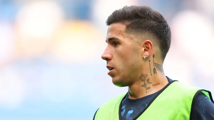 Enzo Fernandez of Chelsea looks on as the team warms up prior to the Premier League match between Chelsea FC and Manchester City FC at Stamford Bridge on August 18, 2024 in London, England.