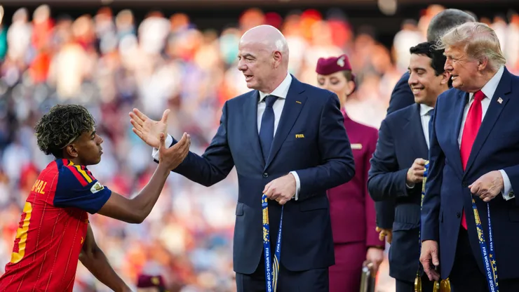 EAST RUTHERFORD, NEW JERSEY - JULY 19: US President Donald Trump and FIFA President Gianni Infantino congratulate Lamine Yamal #19 of Spain as they present him with the Winners Medal after defeating Argentina in the FIFA World Cup 2026 Final at New York New Jersey Stadium on July 19, 2026 in East Rutherford, New Jersey. Spain defeated reigning World Cup champions Argentina, who were led by Lionel Messi, with the lone goal coming from Ferran Torres #7 in the 106th minute of extra time. (Photo by Andrew Harnik/Getty Images)